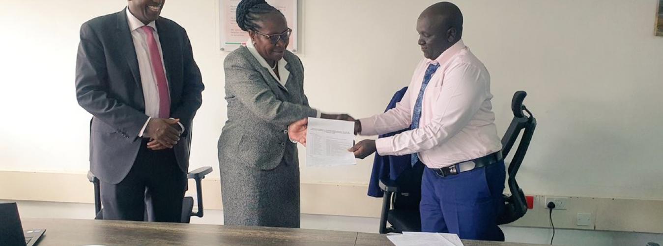 Finance and Strategy Committee Chairperson Ms Celine Orata receiving a signed Copy of an evaluated Performance Contract document. 